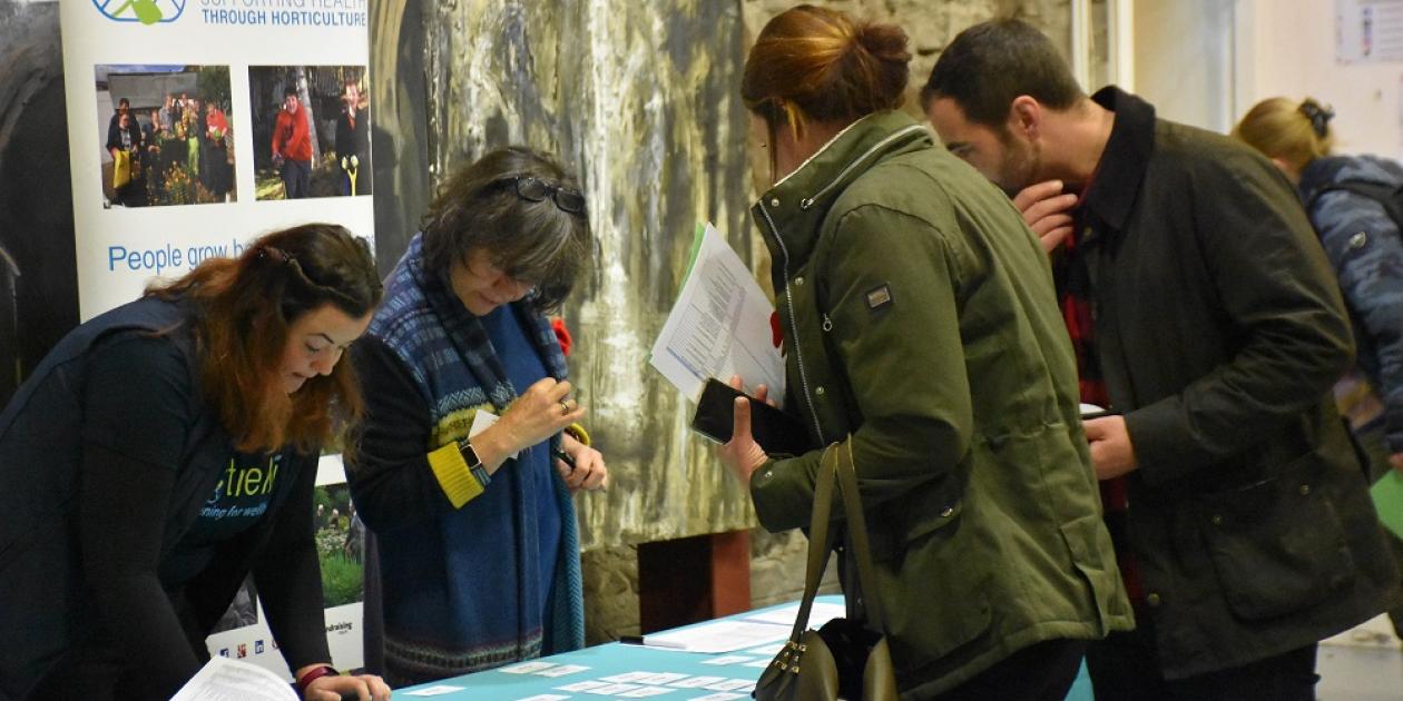 people at Trellis conference registration desk