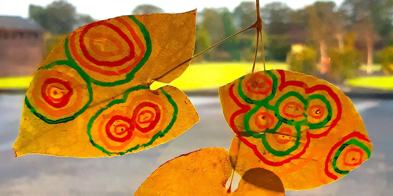 decorated leaves hanging at the window catching the light