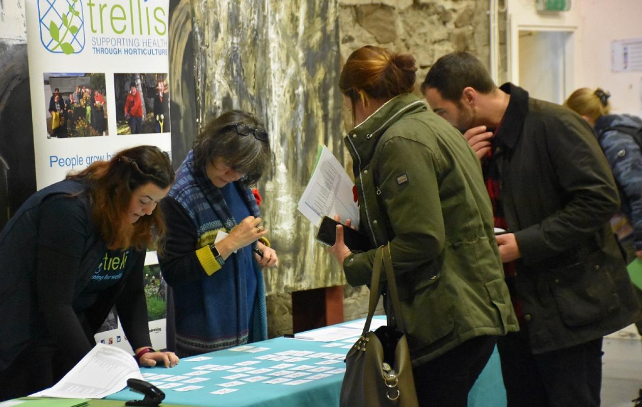 people at Trellis conference registration desk