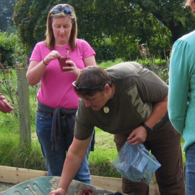 therapeutic gardening training outdoors compost and wheelbarrow